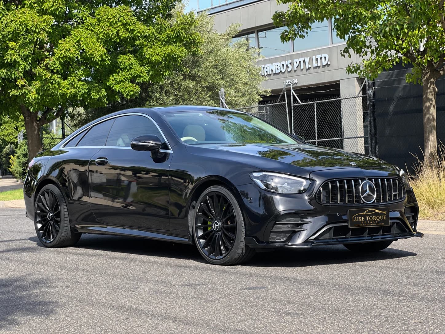 Mercedes E-Class coupé with a black exterior and branded plate